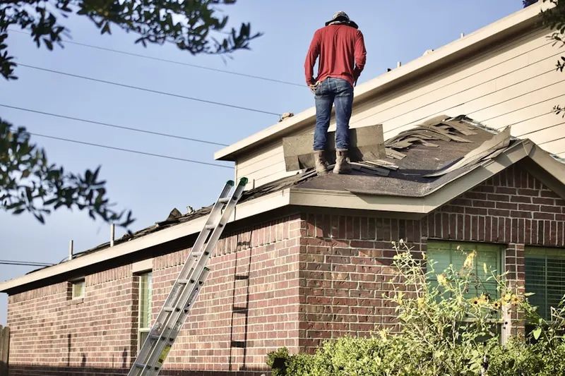 Professional roofer working on a residential roof in Pahokee